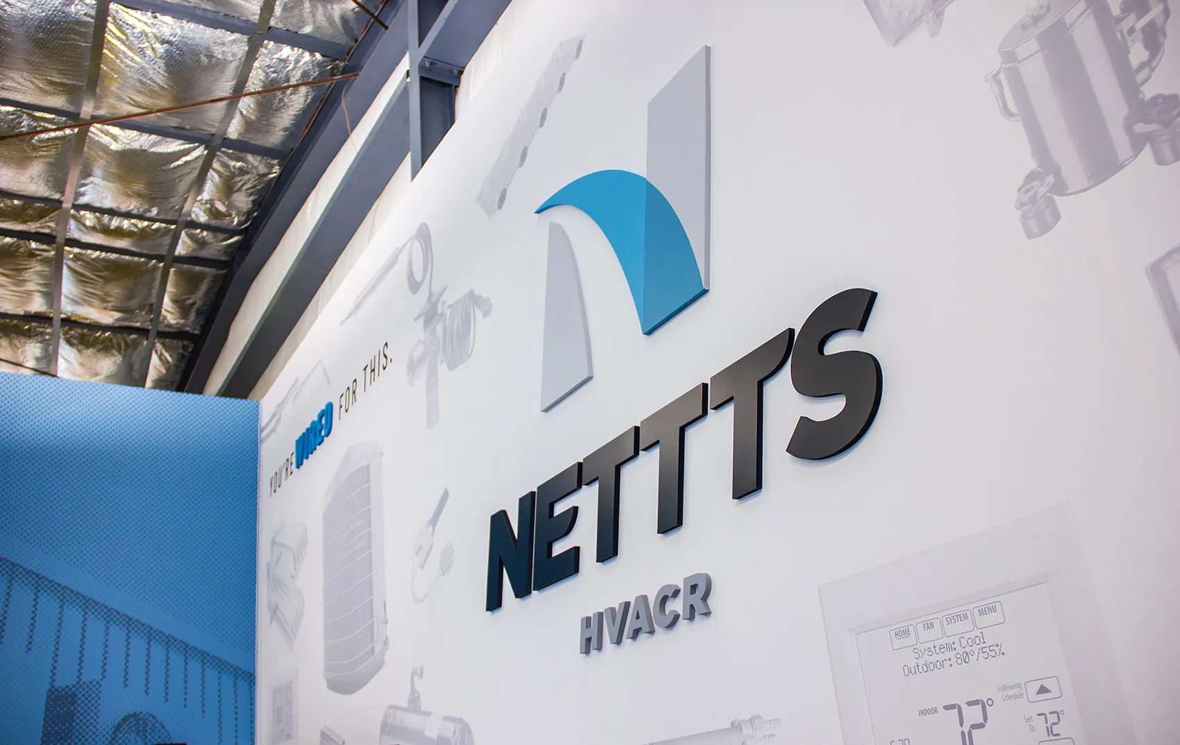 3-dimensional NETTTS logo on the wall